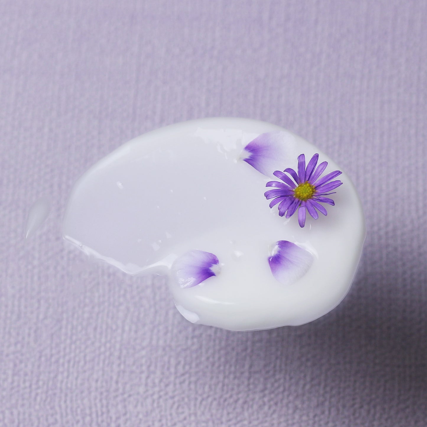 A swatch of Bakuchiol Smoothing Serum with tiny flowers and petals