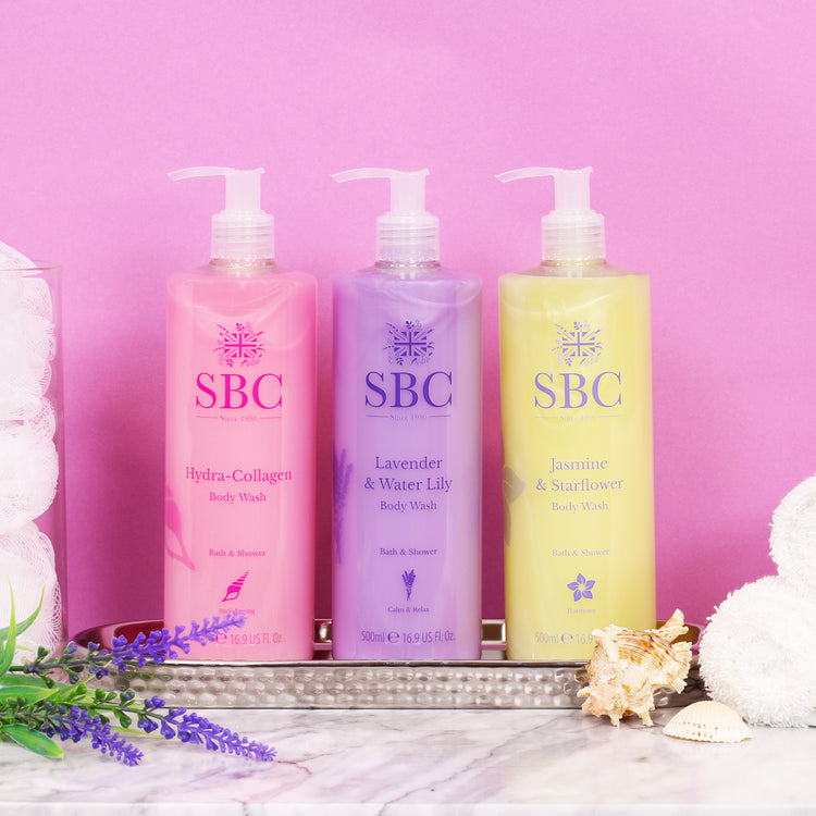 Hydra-Collagen, Lavender and Jasmine & Starflower Body washes in a silver dish on a pink background 