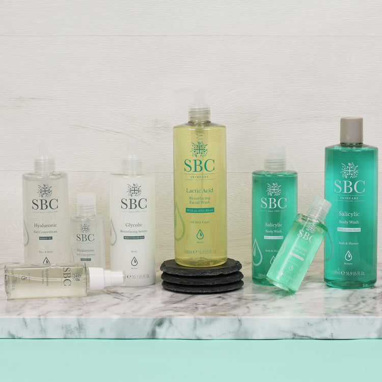 All of the Acid range products on a marble counter with a white wash wood background 