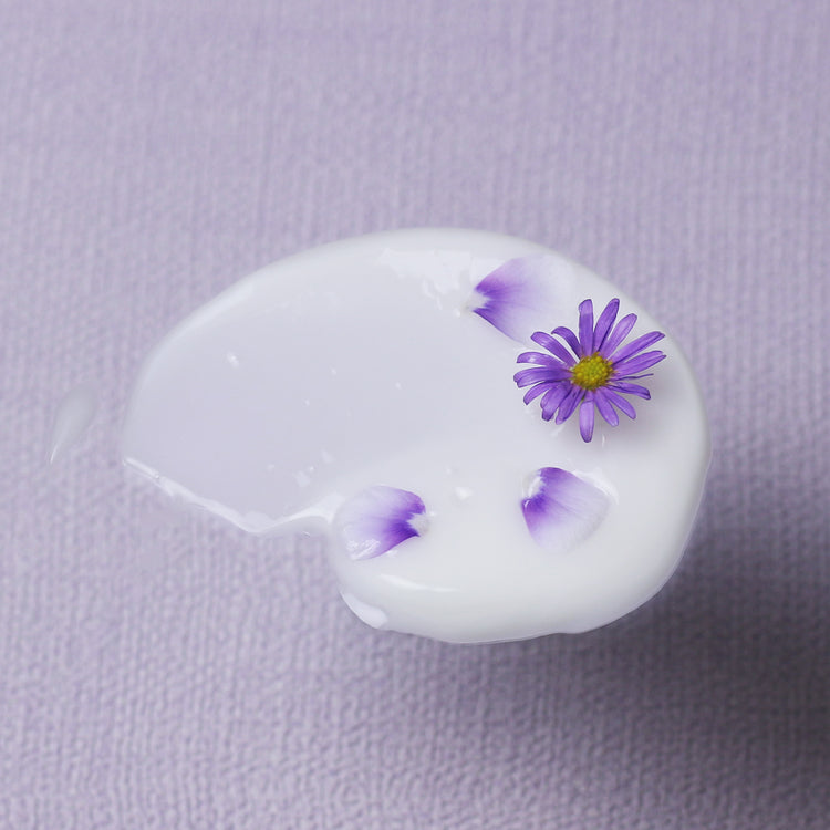 Swatch of serum with purple petals 