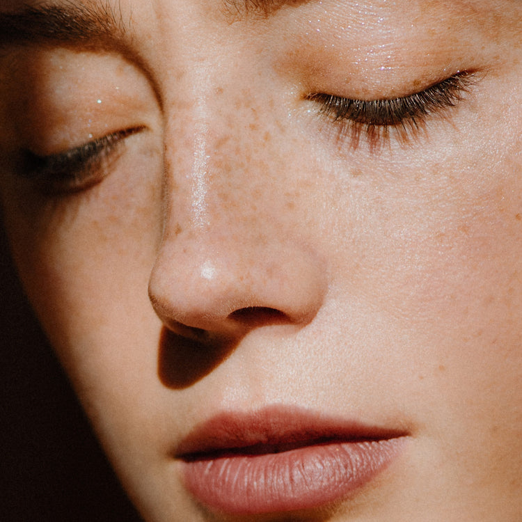 Close up of woman's face with freckles