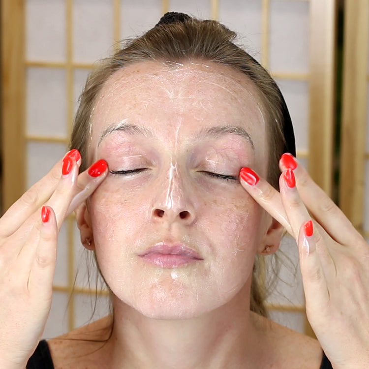 Woman cleansing her face 