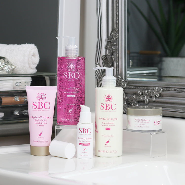 Hydra-Collagen Products on a bathroom sink in front of a mirror 