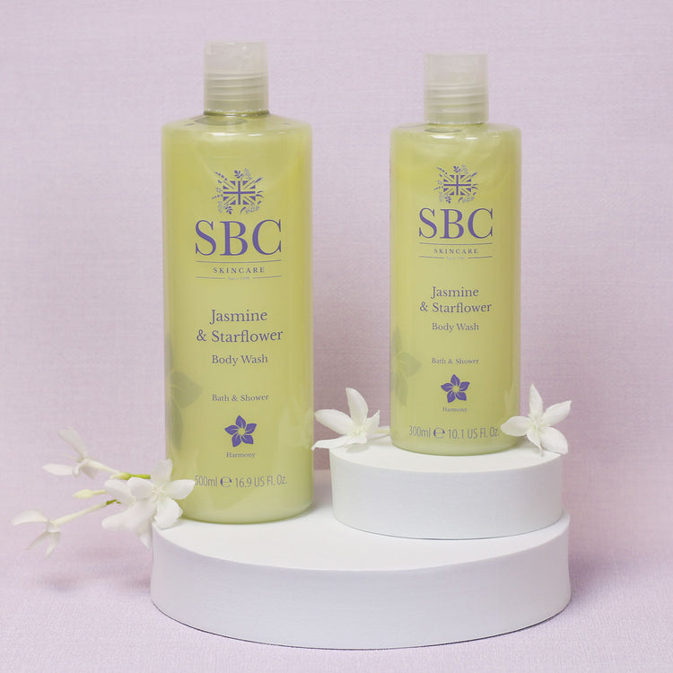 Jasmine & Starflower Body Was on a white plinth with jasmine flowers 