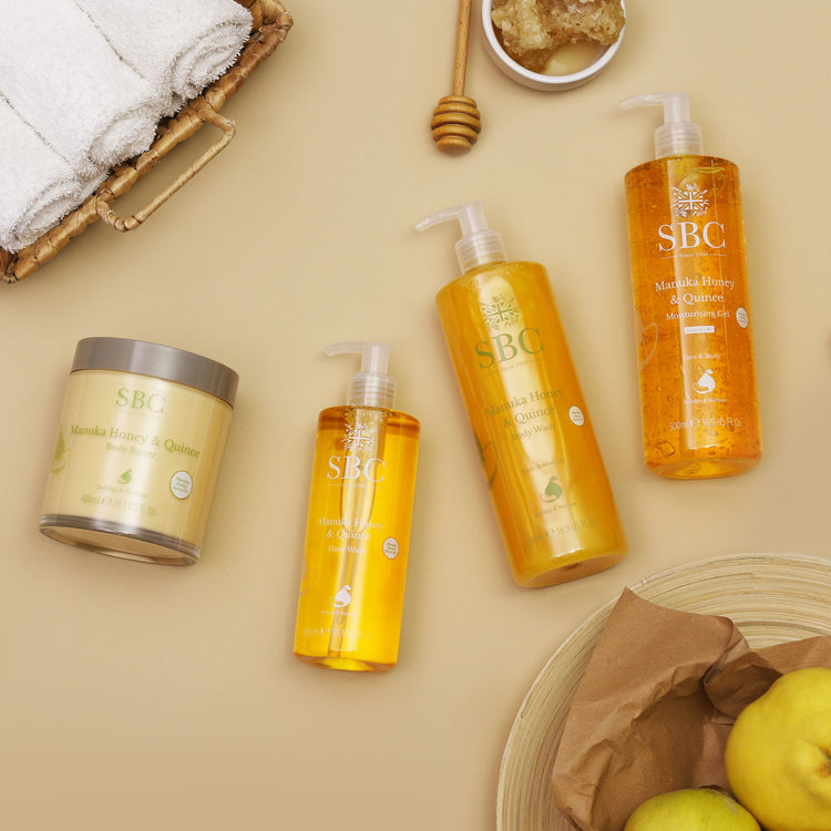 Manuka Honey & Quince products on brown paper with towels, quince fruit and honey combs