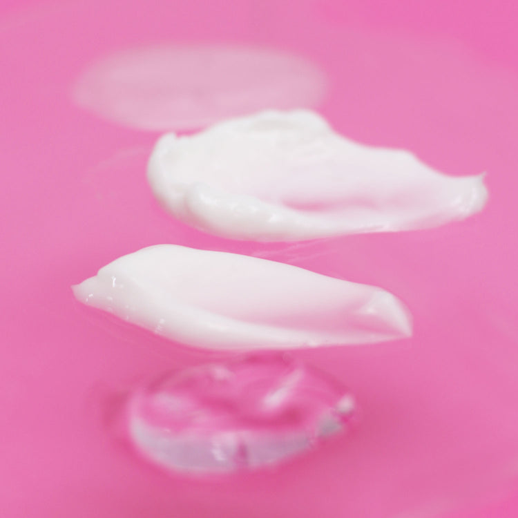 Swatches of Hydra-Collagen Moisturisers on a pink background