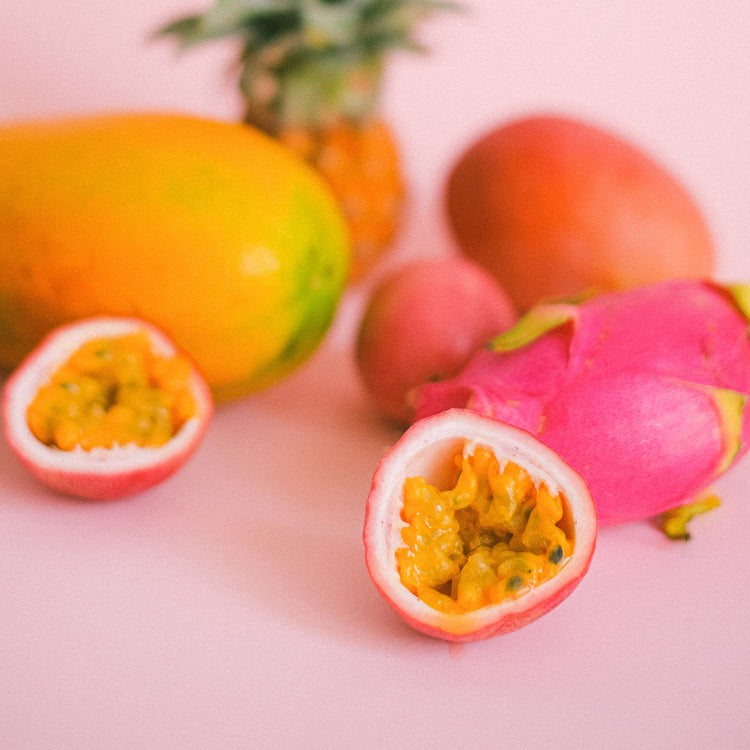 Sliced fruit on a pink background 