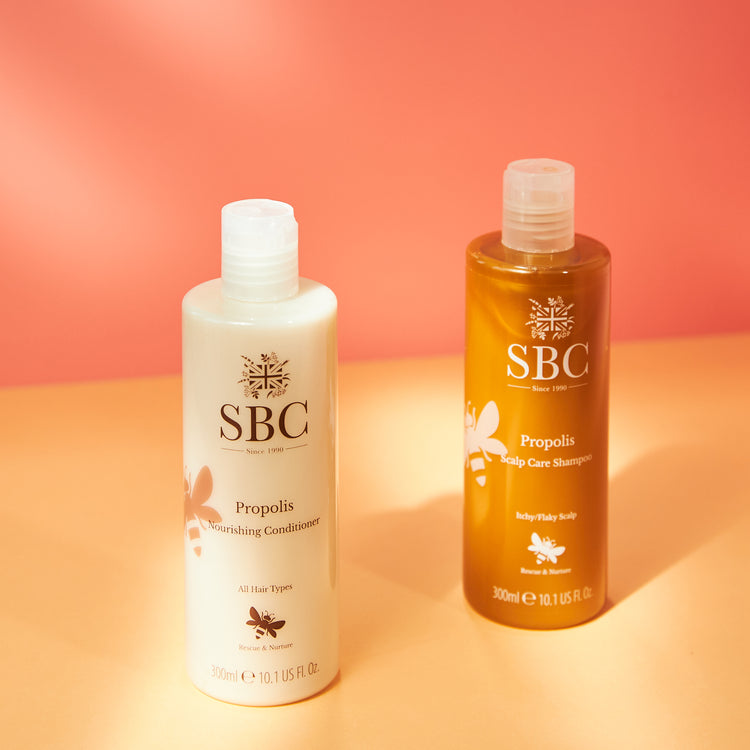 Propolis Scalp Care Shampoo and Conditioner on an orange and yellow background 