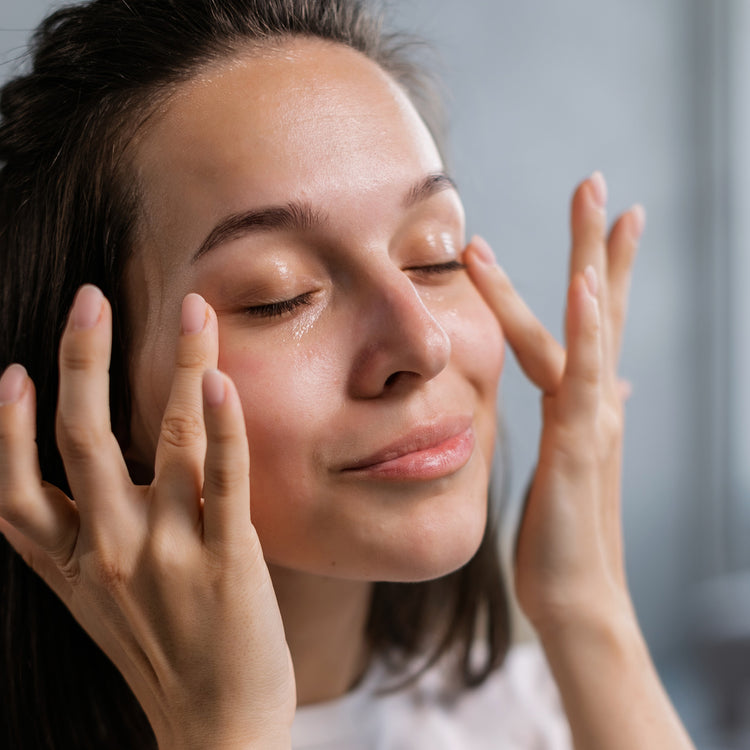 Woman applying skincare around eye area