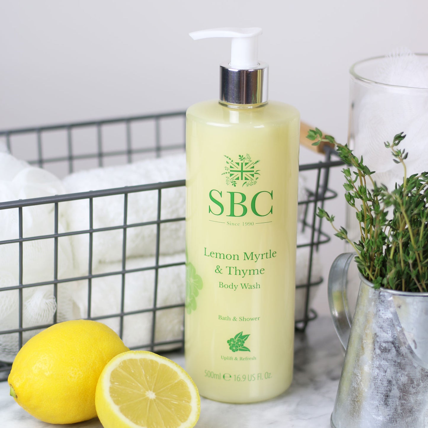 500ml Lemon Myrtle & Thyme Body Wash with lemon wedges and a container of thyme 
